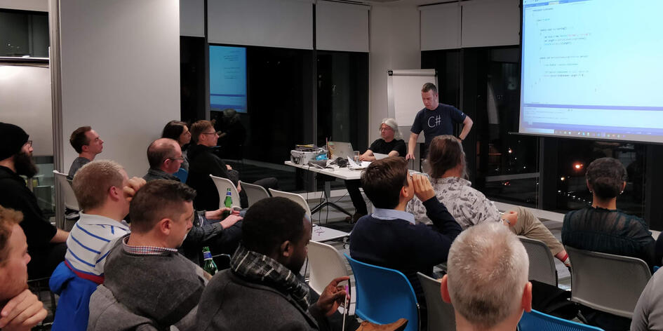 A presenter talking while the audience listens