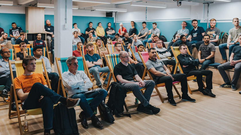 A room full of people watching a talk
